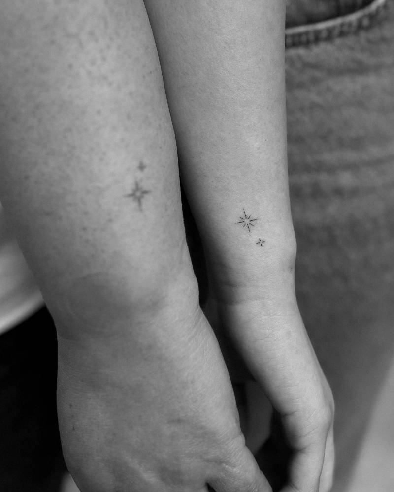 Matching minimalistic stars tattoo for mother and daughter.