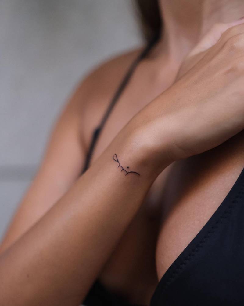 "Patience" in arabic tattooed on the wrist.