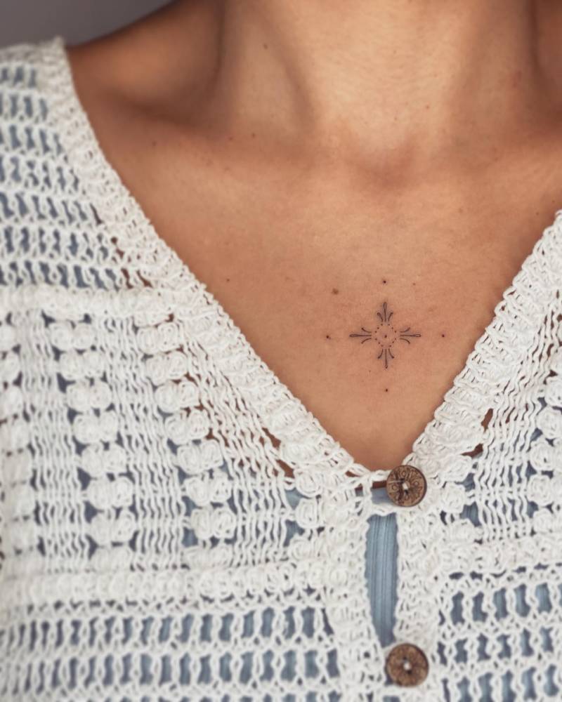 Minimalistic ornament tattoo located on the chest.