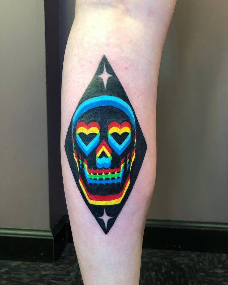 Heart skull tattoo in pop art style located on the calf.