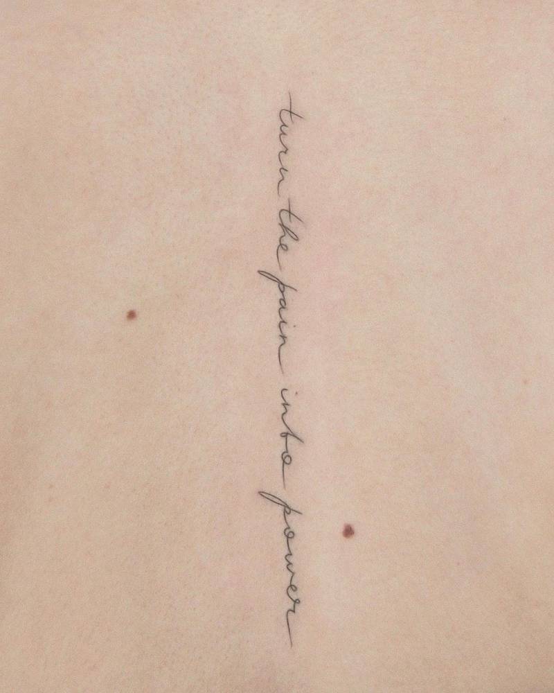 "Turn the pain into power" lettering tattoo