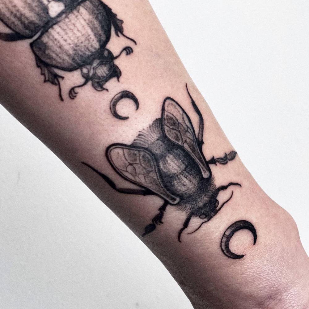 Fly tattoo located on the wrist.