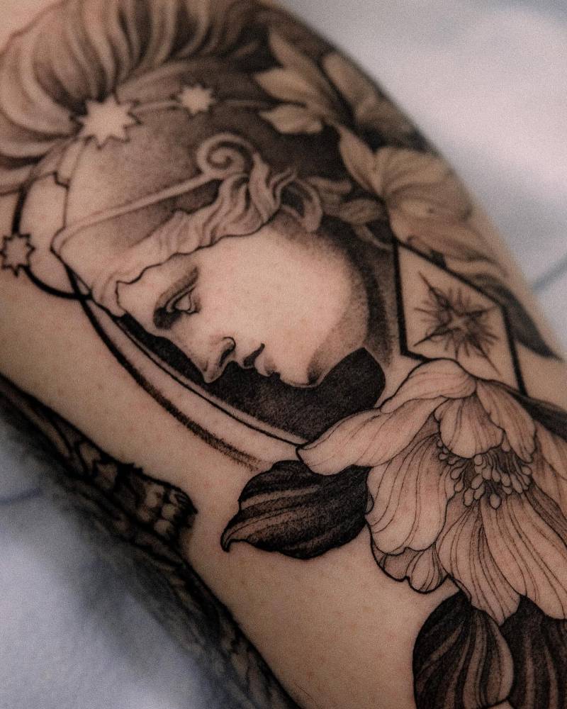 Athena portrait tattoo located on the calf, illustrative style.