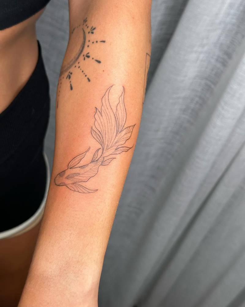 Koi fish tattoo located on the forearm.