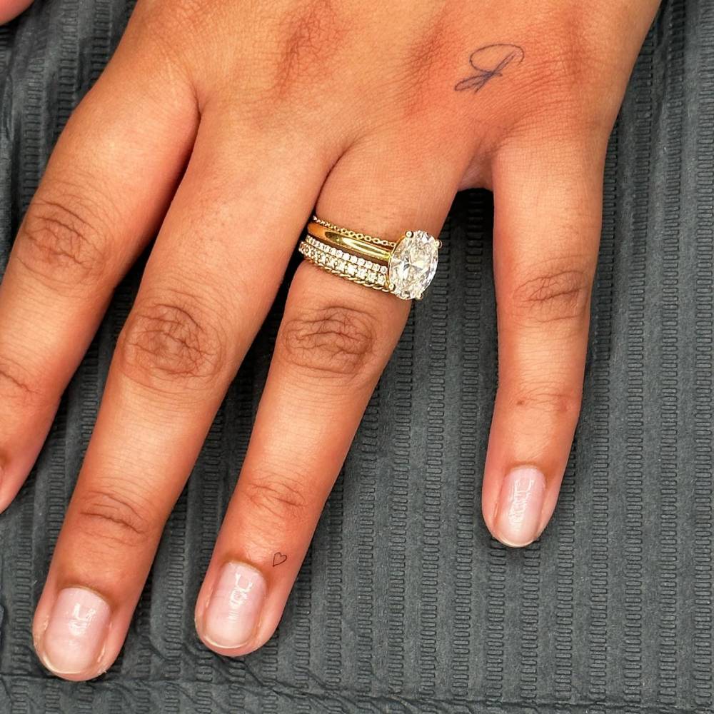 Micro heart tattoo placed on the finger.