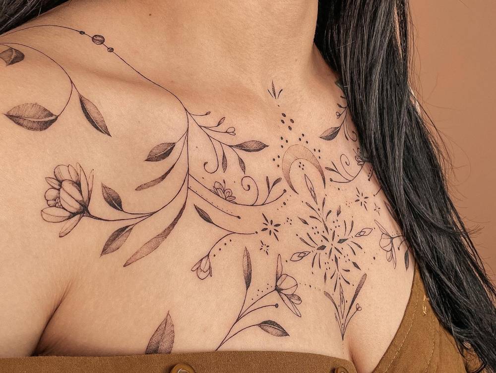 Ornamental floral design tattooed on the chest.