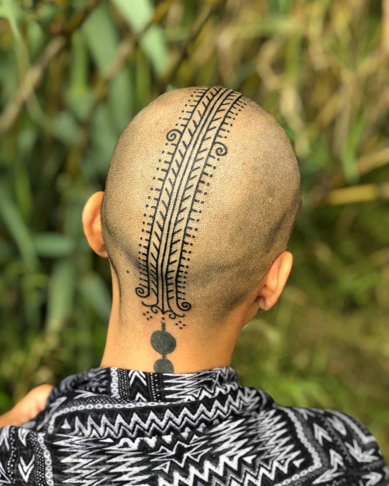 Ornamental tattoo located on the head, blackwork style.