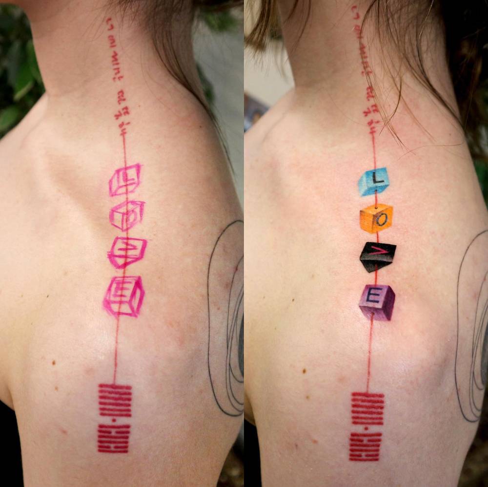 Pop art style word "love" letter cubes tattooed on the top of shoulder.
