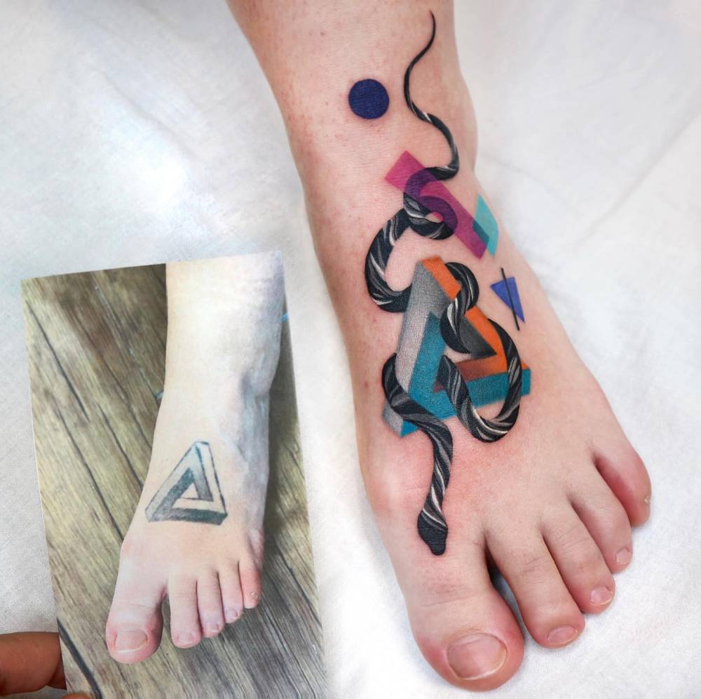 Penrose triangle and snake tattoo cover-up done on the foot.