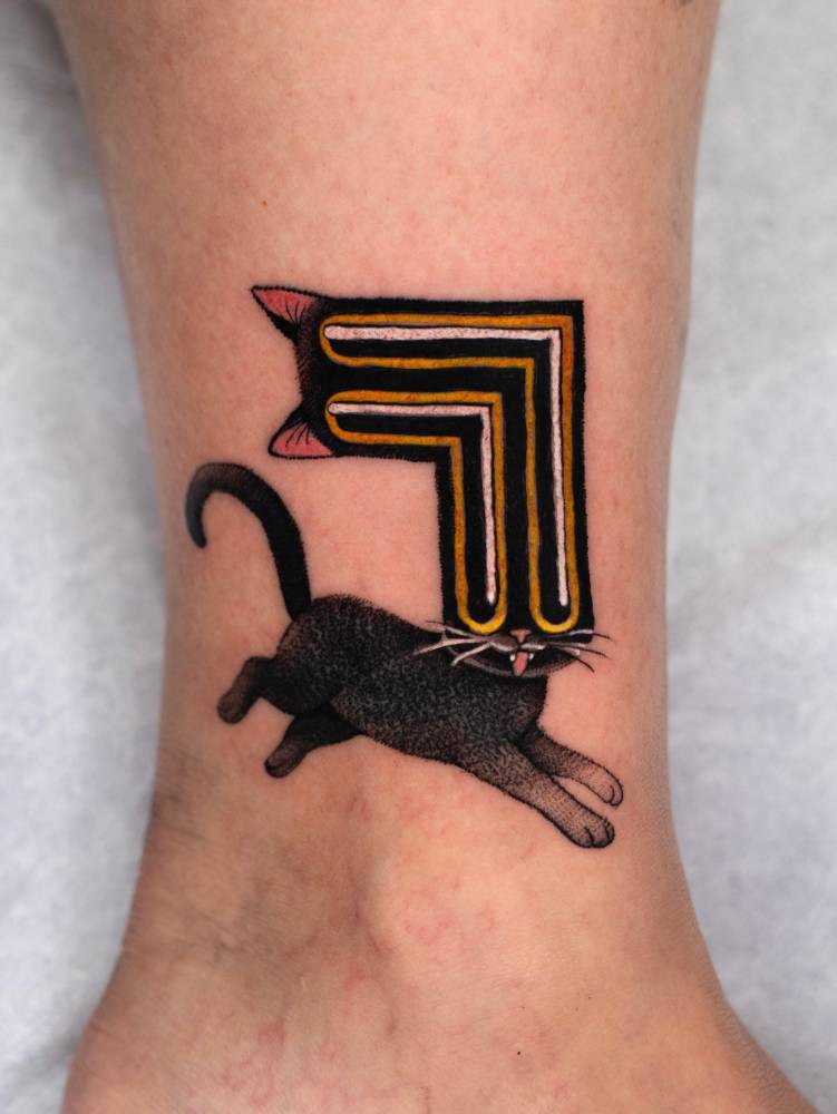 Pop art style trippy cat tattoo located on the ankle.