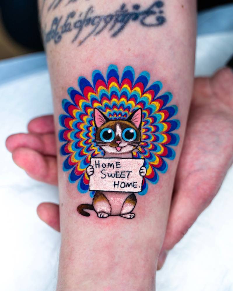Psychedelic style cat tattoo done on the inner forearm.