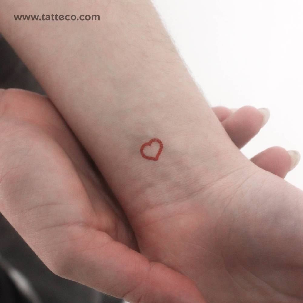 Tiny minimalistic red heart outline temporary tattoo.