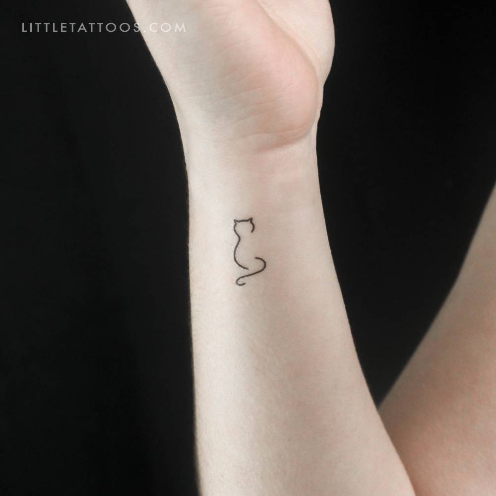 Minimalist cat temporary tattoo located on the wrist.