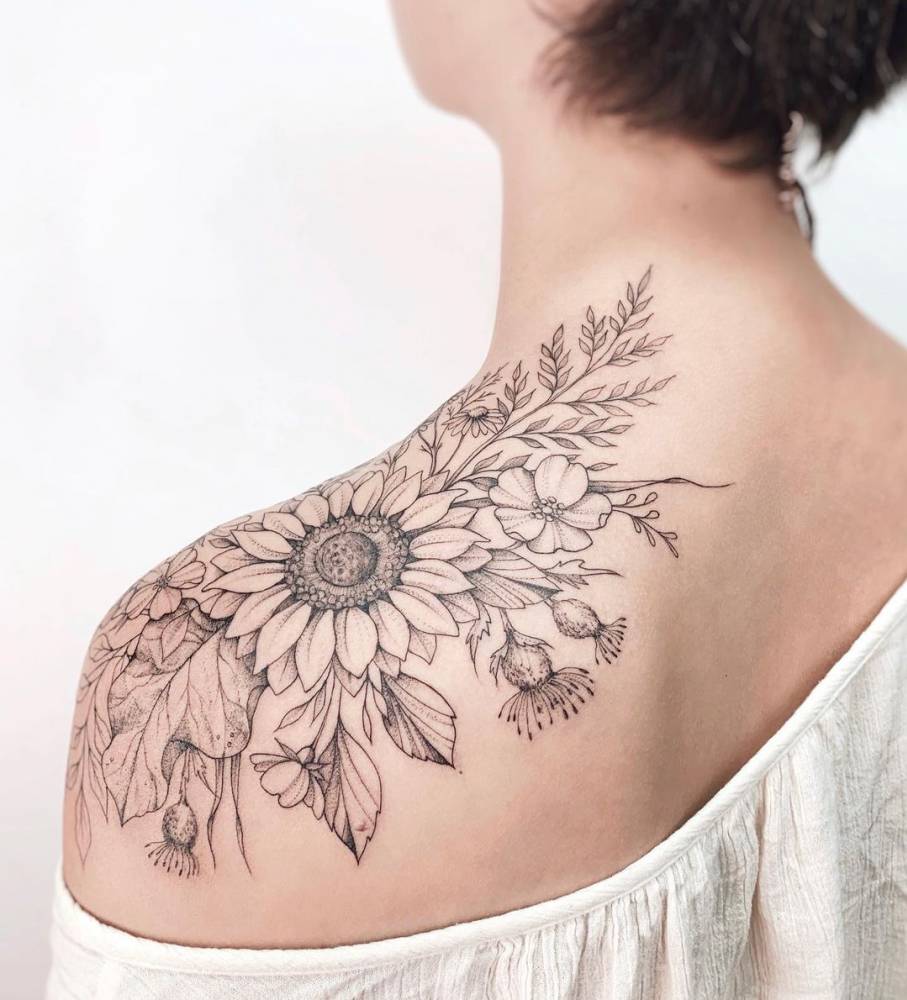 Sunflower tattoo located on the shoulder.