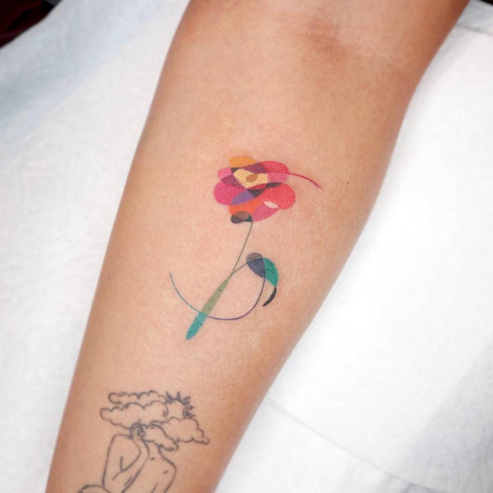 Abstract style Love your self Flower tattoo located on the inner forearm.