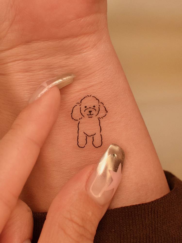 Minimalistic style little Poodle tattoo done on the wrist.
