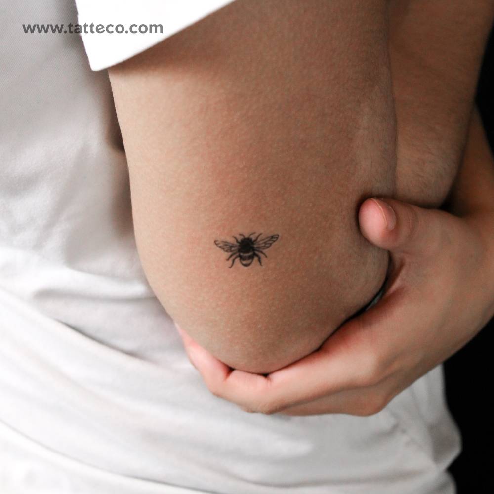Hand-drawn bee semi-permanent tattoo located on the tricep.
