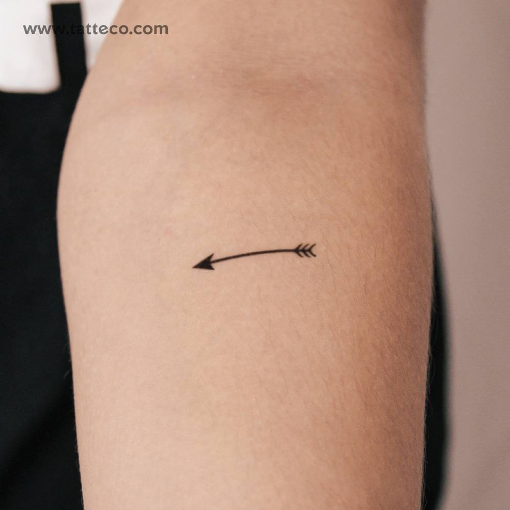 Minimalistic style arrow semi-permanent tattoo located on the inner forearm.