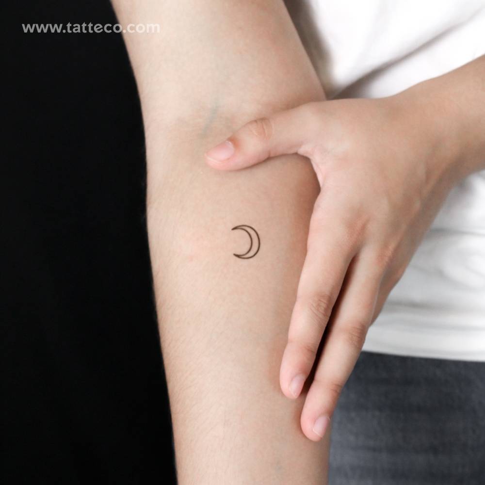 Crescent moon outline semi-permanent tattoo located on the inner forearm.