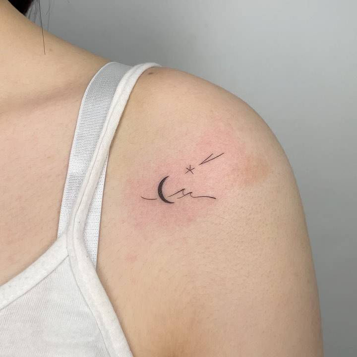 Shooting star, moon and wave tattoo done on the shoulder, minimalistic style.