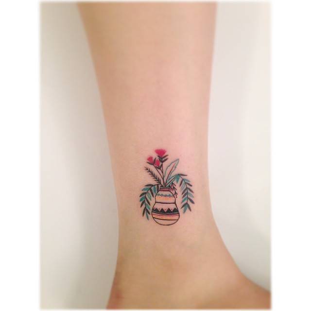Vase and plants tattoo located on the ankle, illustrative style.