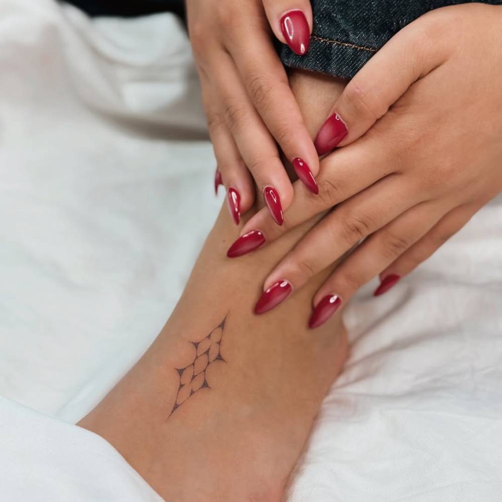 Ornamental design tattooed on the foot.