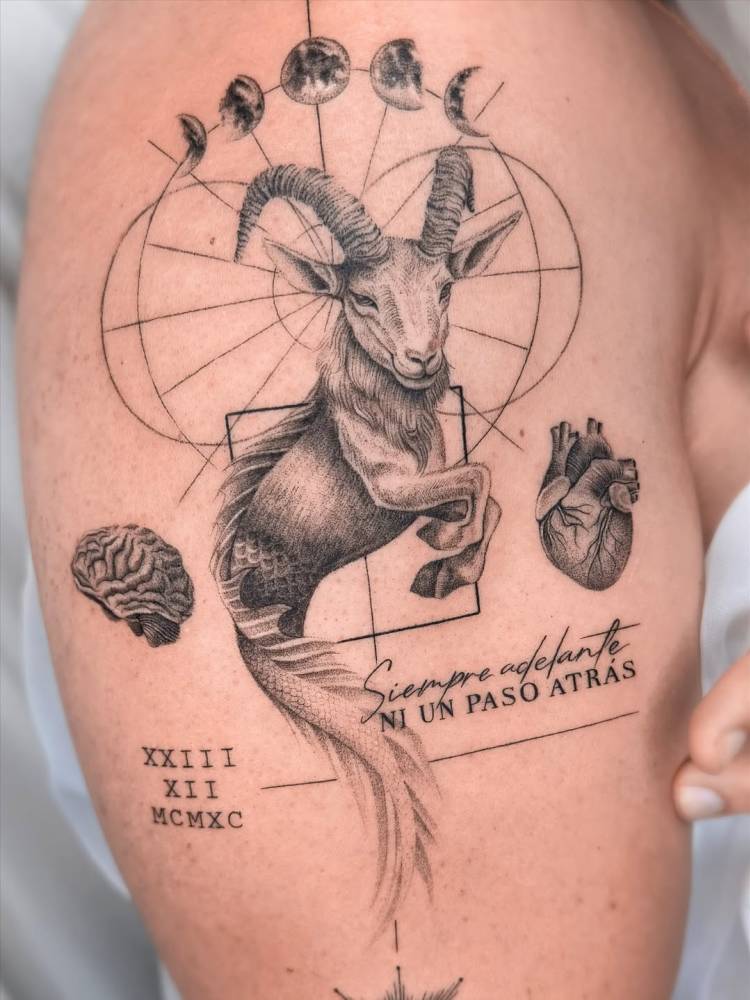 Graphic style sea goat and moon phases tattoo located on the upper arm.