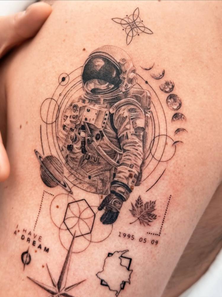 Astronaut tattoo in graphic style located on the upper arm.