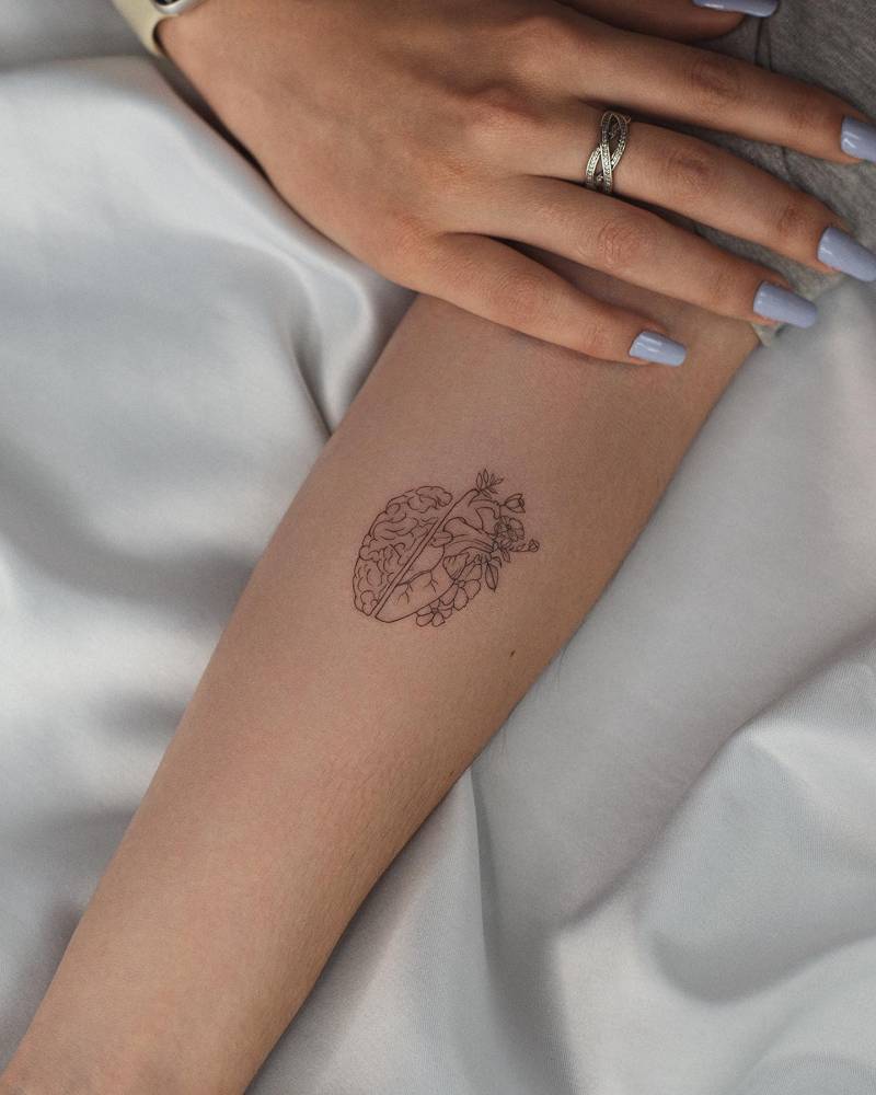 Heart vs. Brain tattoo located on the inner forearm, fine line style.