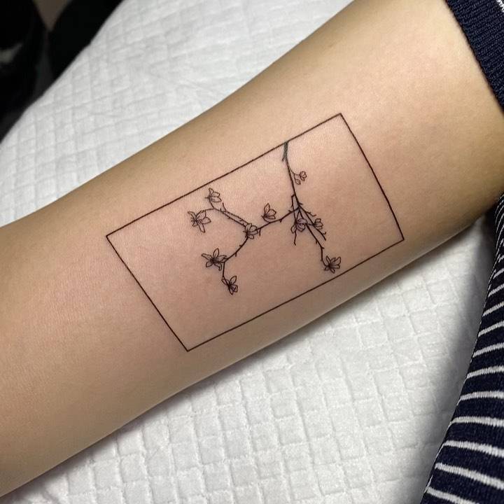 Plum blossom tattoo on the inner arm.