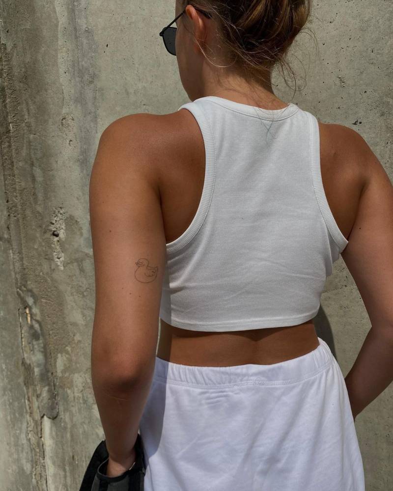 Fine line duck tattoo on the tricep (healed).