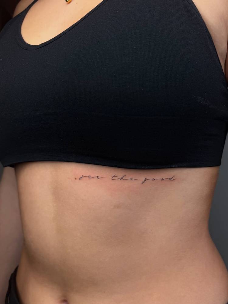 "See the good" lettering tattoo located on the rib.