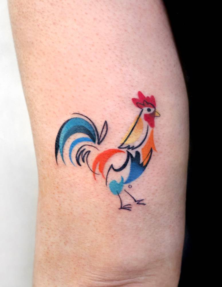Pop art style rooster tattoo placed on the tricep.