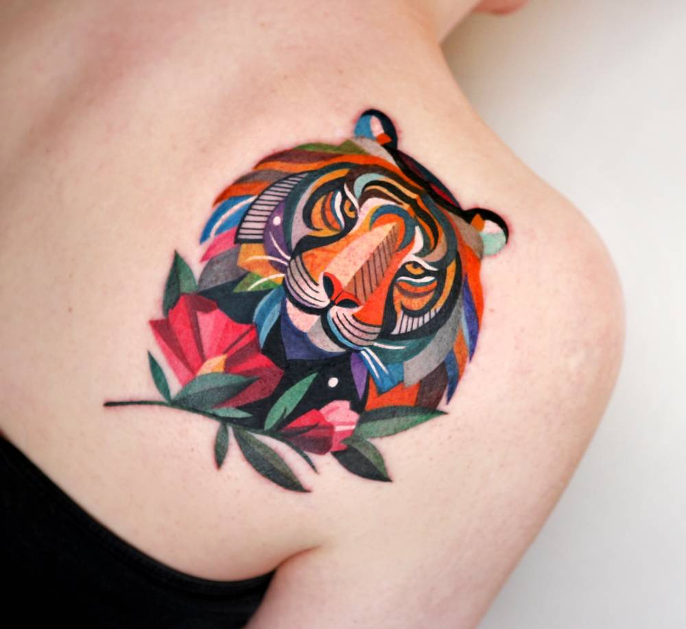 Tiger portrait tattoo located on the shoulder blade.