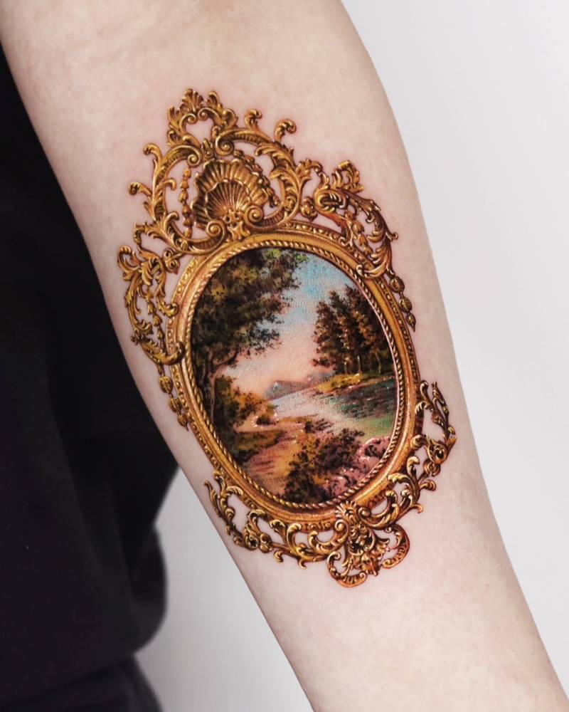 Frame and landscape tattoo located on the inner forearm, micro-realistic style.