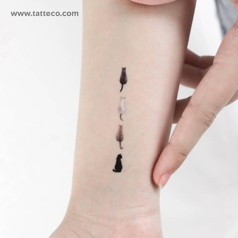 Four cats temporary tattoo located on the wrist.