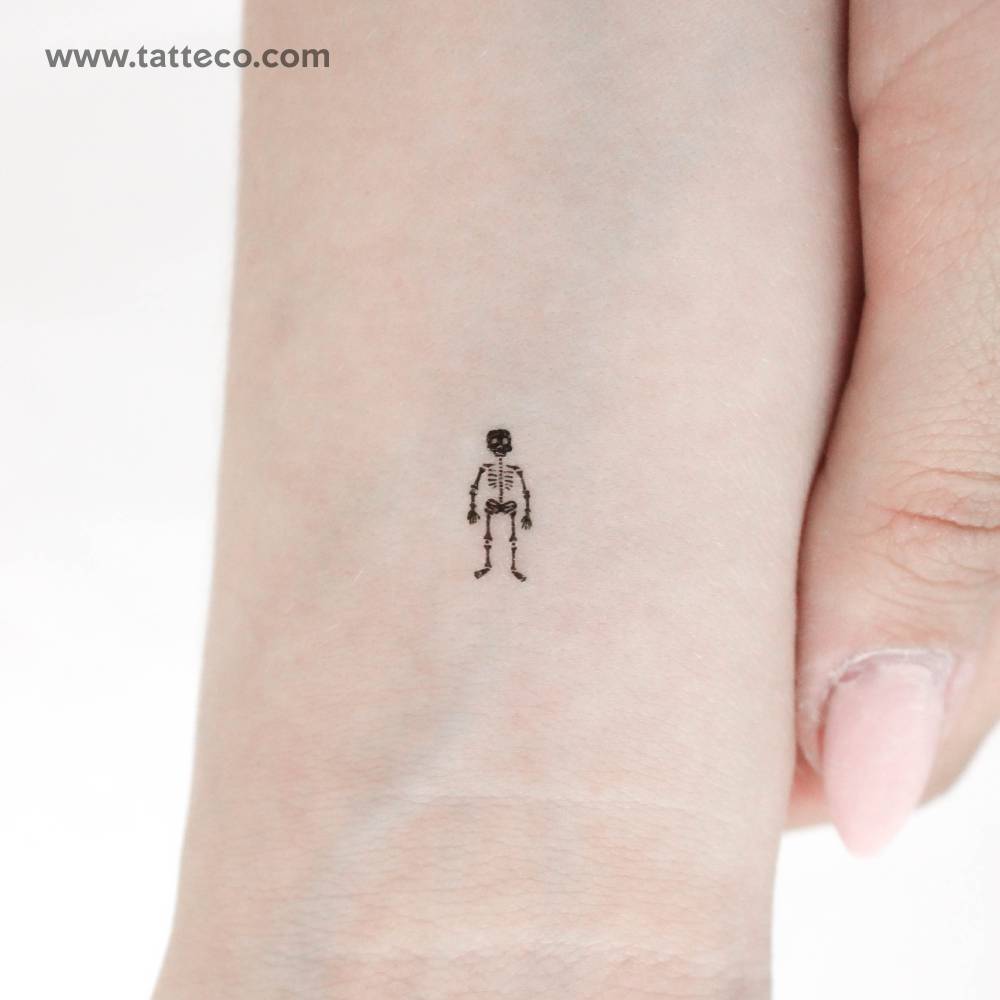 Tiny skeleton temporary tattoo located on the wrist.
