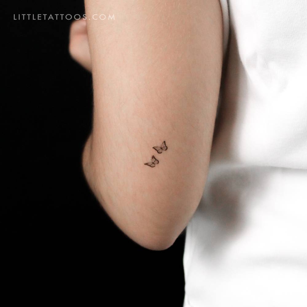Tiny butterfly couple temporary tattoo placed on the tricep.