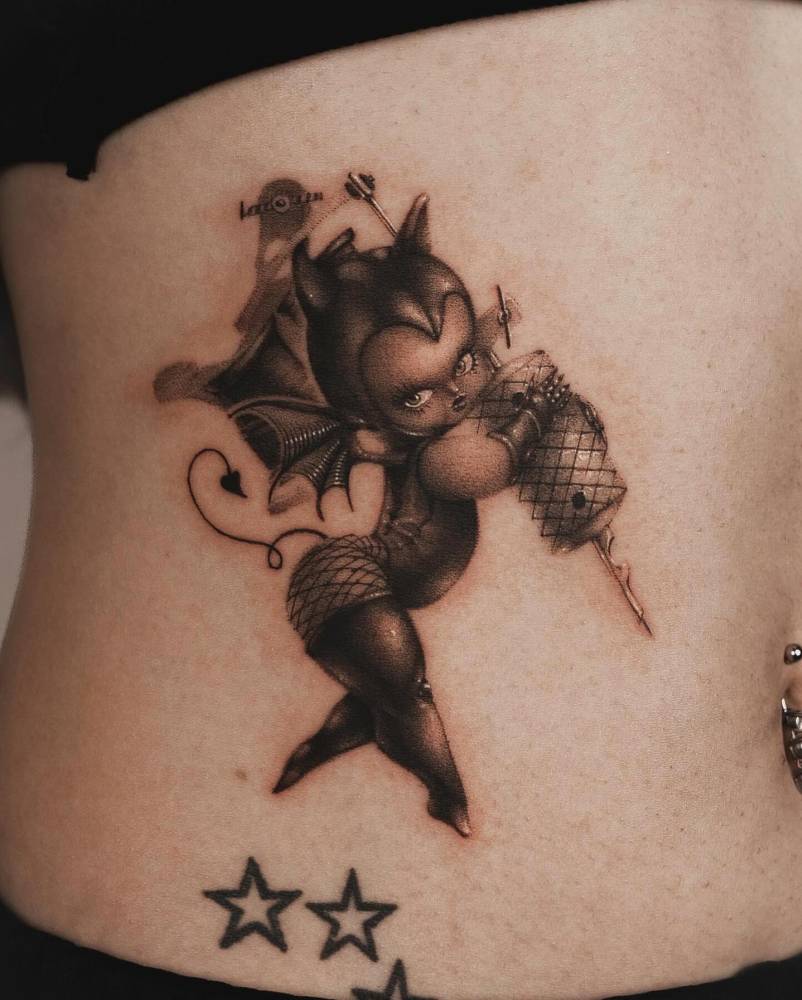 She-devil Kewpie tattoo located on the waist, cartoon style.
