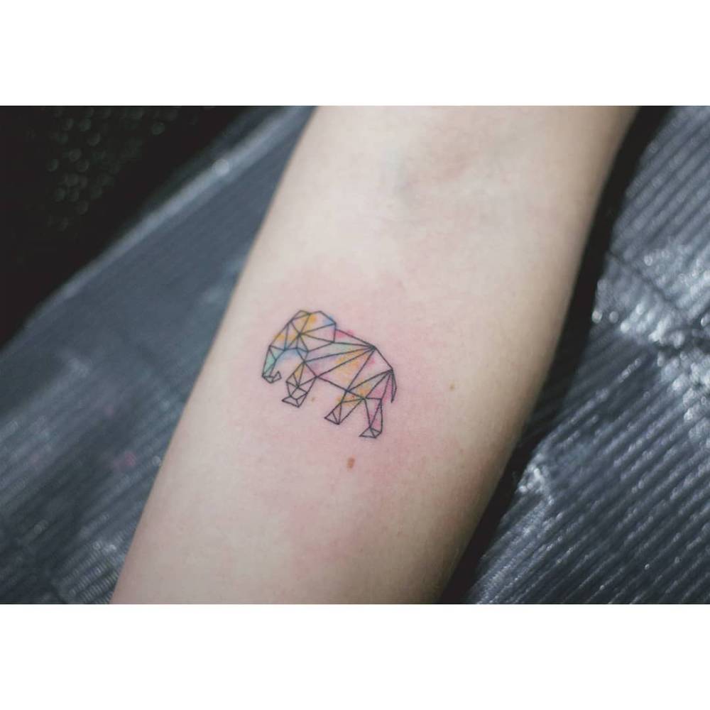Low poly elephant tattoo placed on the inner forearm.