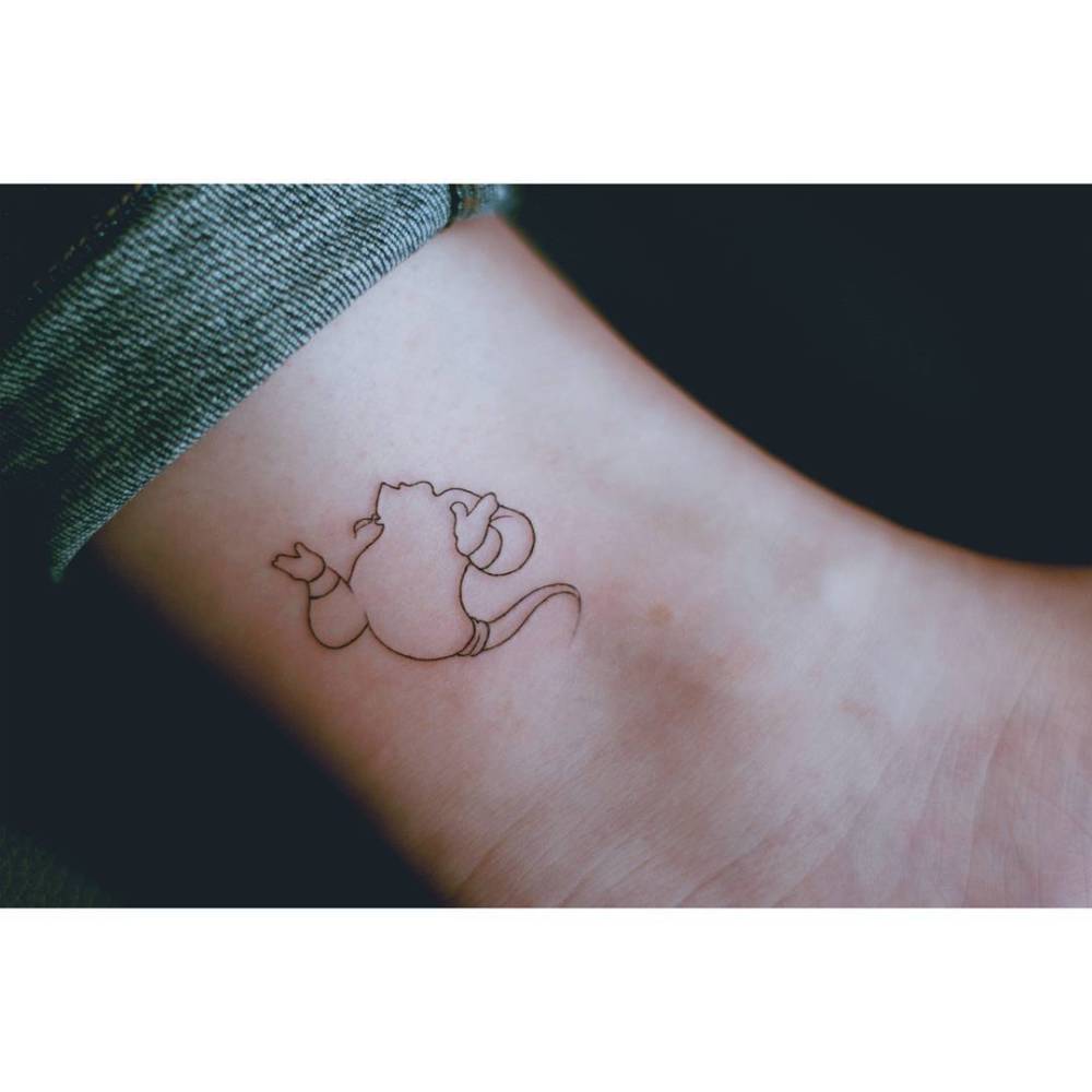 Aladdin's Genie tattoo located on the ankle, fine line style.