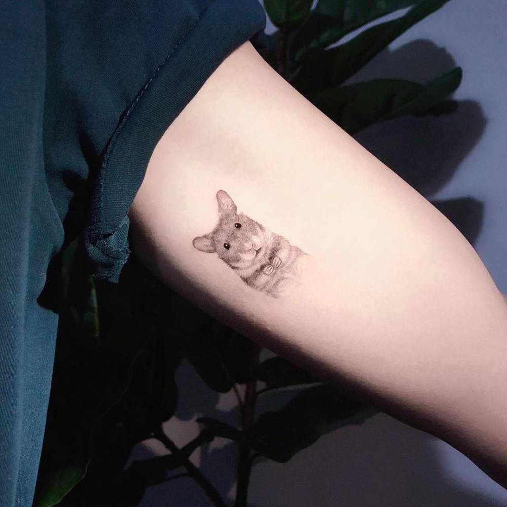 Hamster portrait tattoo in micro-realistic style located on the inner arm.