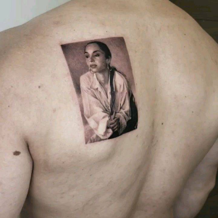 Sade portrait tattoo in micro-realistic style.