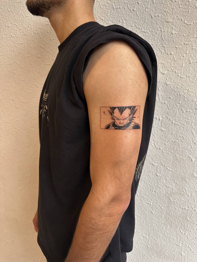 Vegeta portrait tattoo in cartoon style located on the upper arm.