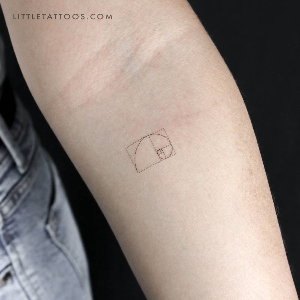 Small golden spiral temporary tattoo in fine line style.