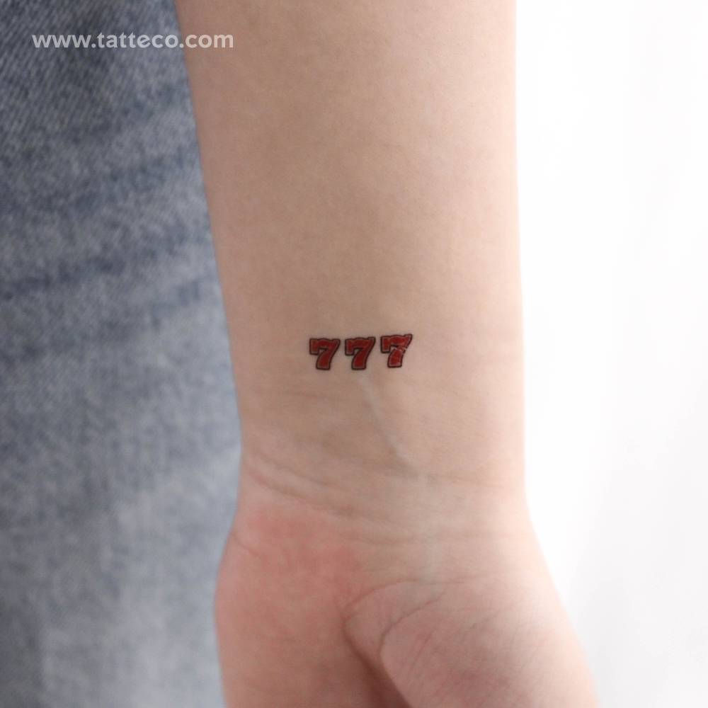 Number "777" temporary tattoo located on the wrist.