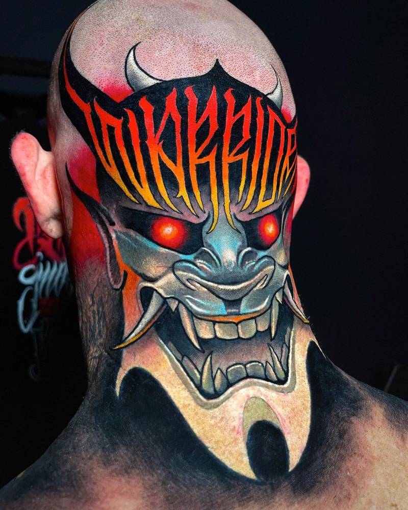 Hannya mask and the word "warrior" tattooed on the head.