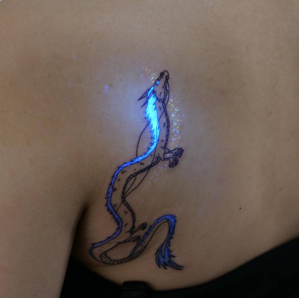 Cartoon style Haku tattoo located on the shoulder blade.