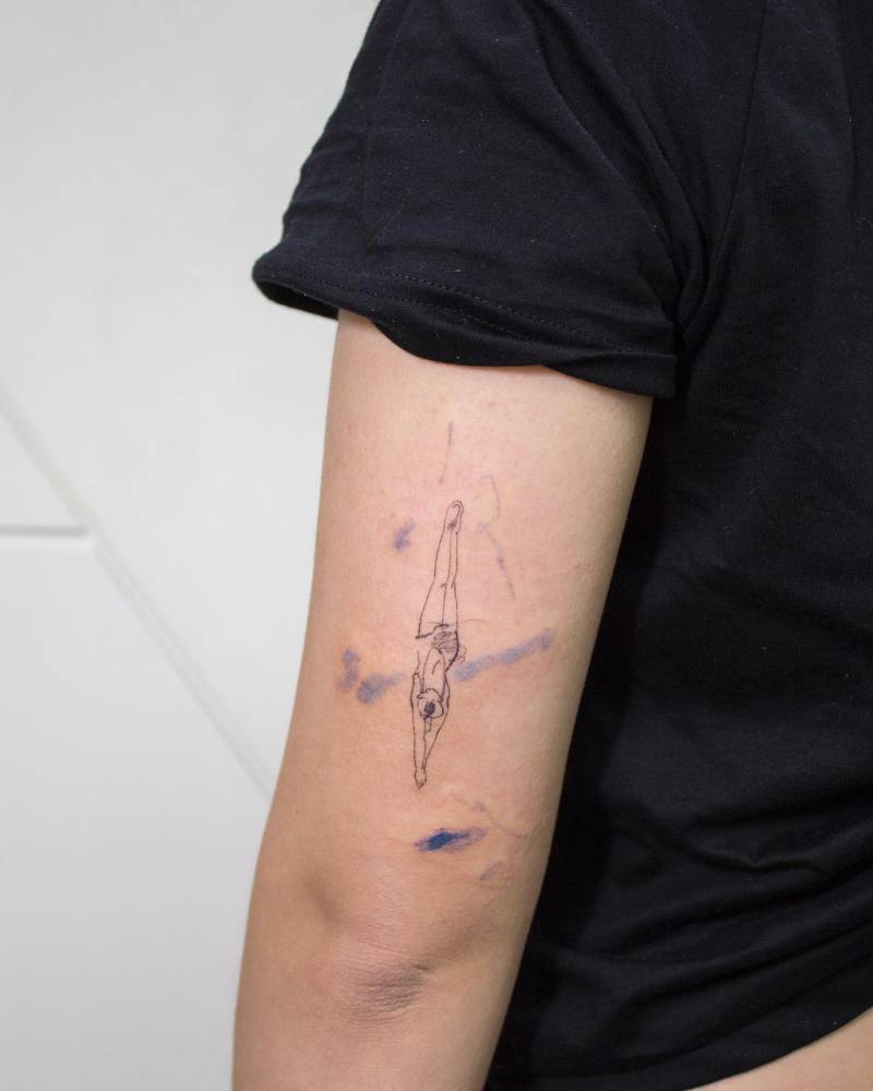 Sketch work style high diving tattoo done on the tricep.