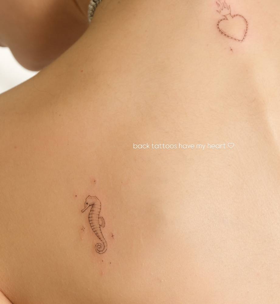 Single needle seahorse tattoo located on the shoulder blade.